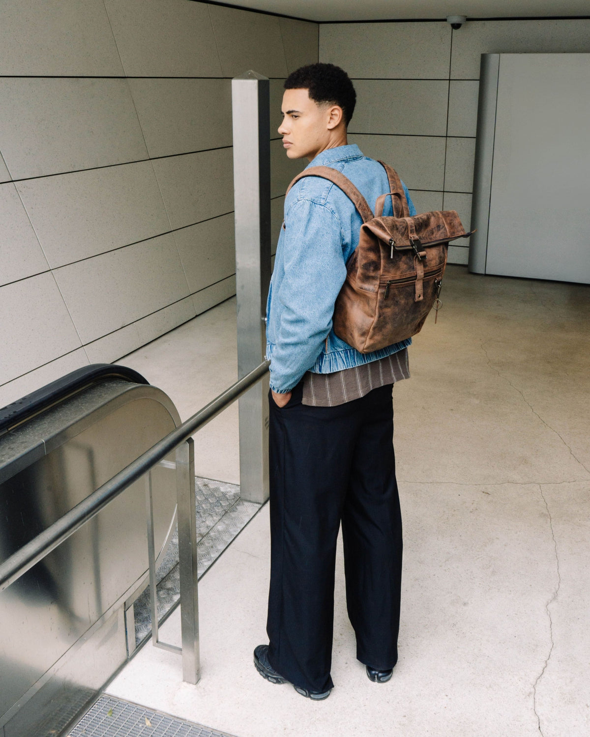 Back view of man wearing earth leather backpack bag