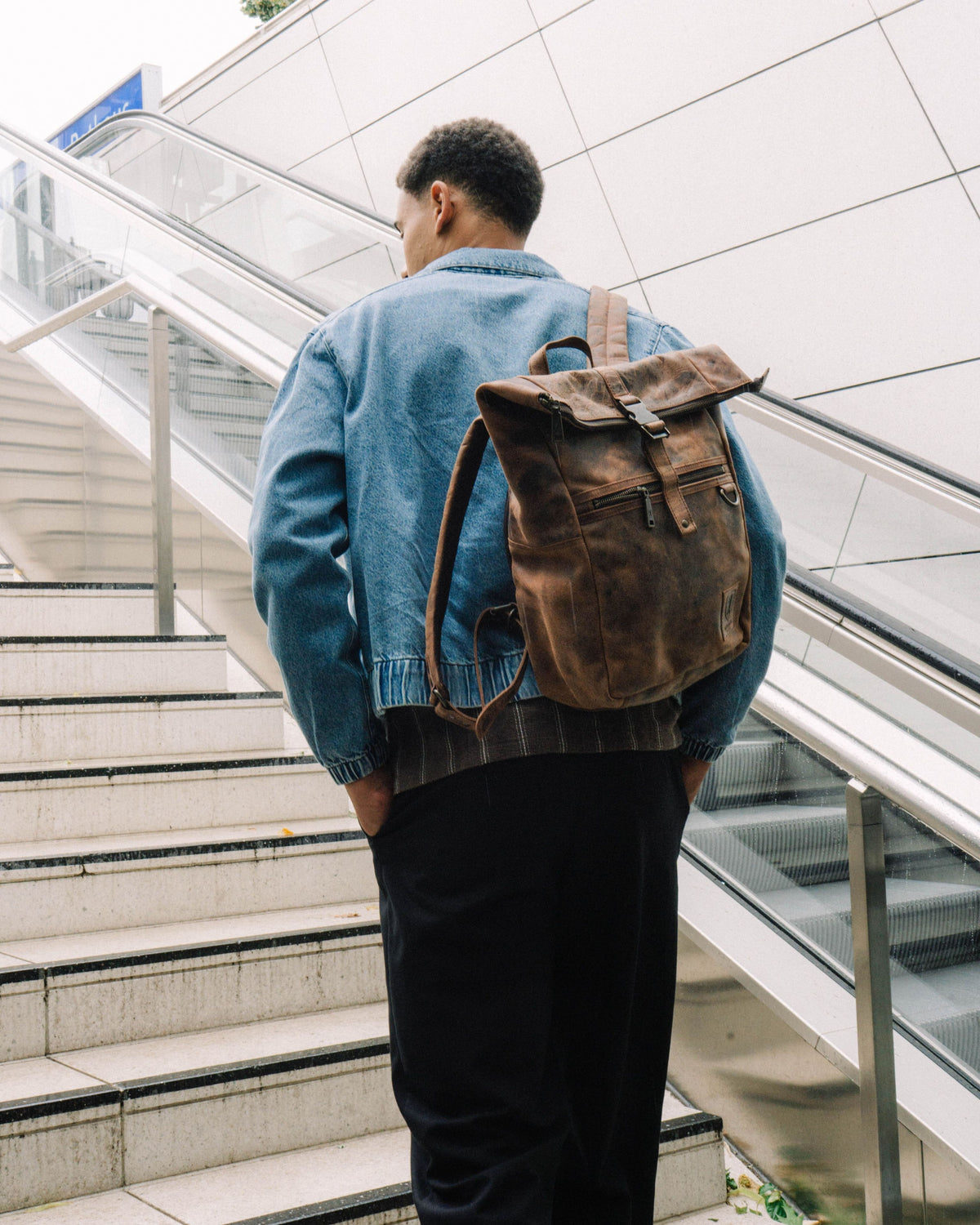 Back view of man wearing earth leather backpack bag