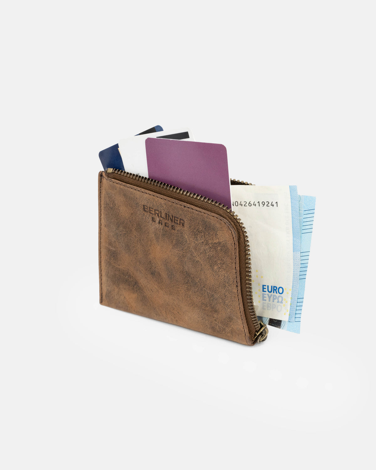 A walnut leather wallet holding cash and cards