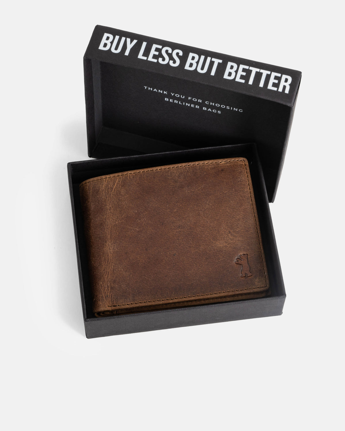 A walnut leather wallet without ID flap inside branded box