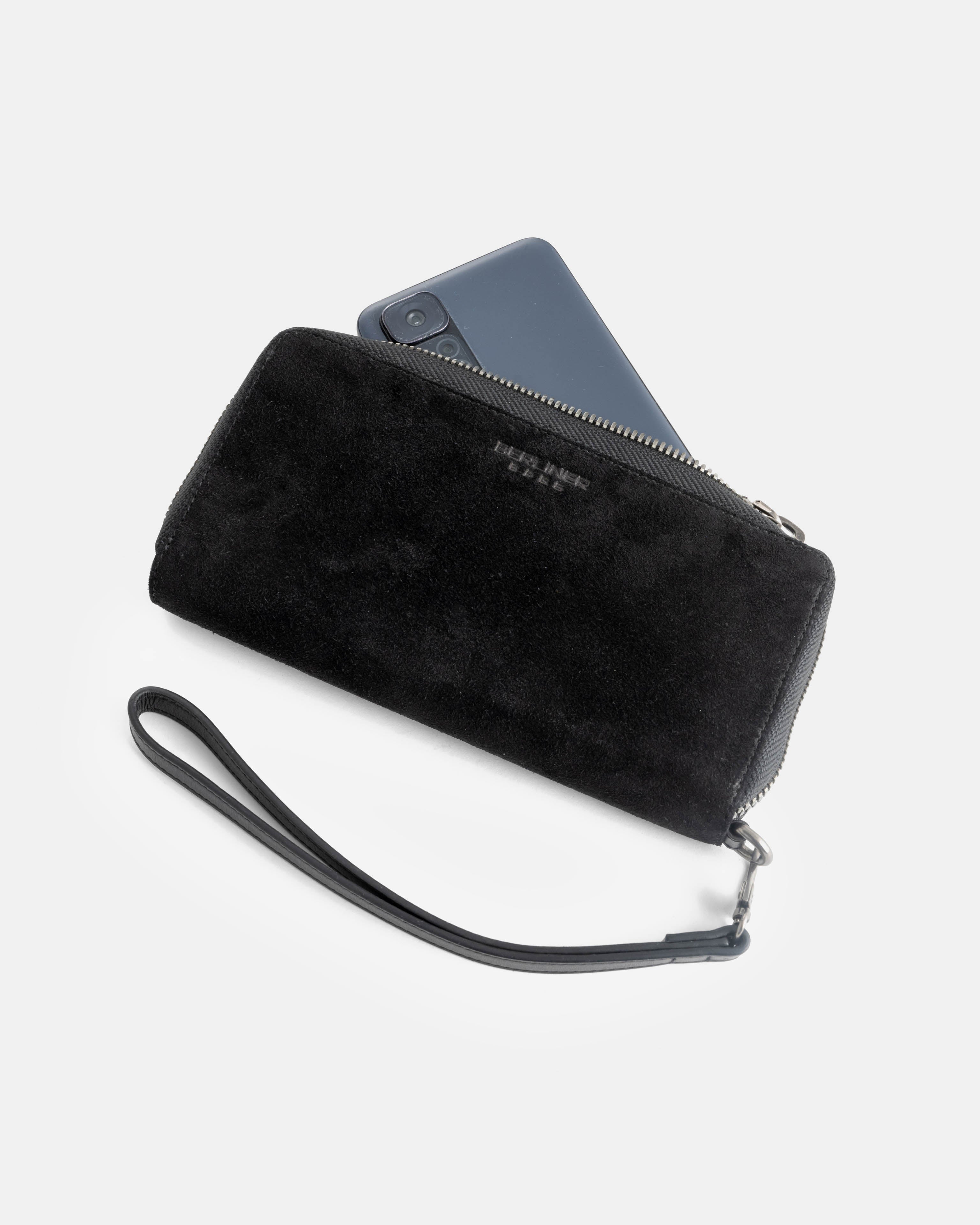 A suede black leather wallet shown with a smartphone in it.