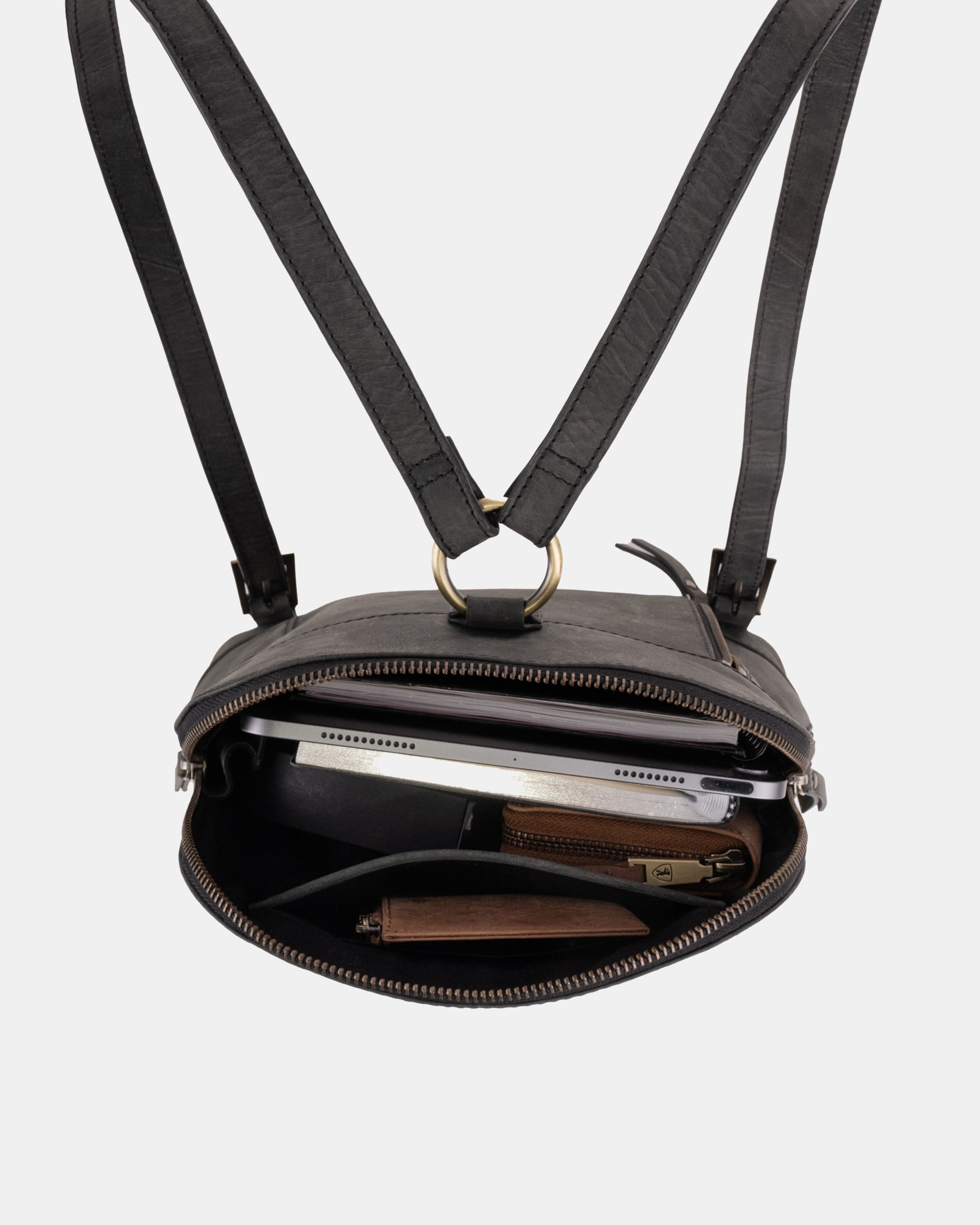 Top-down view of open dark grey leather zip-around backpack.