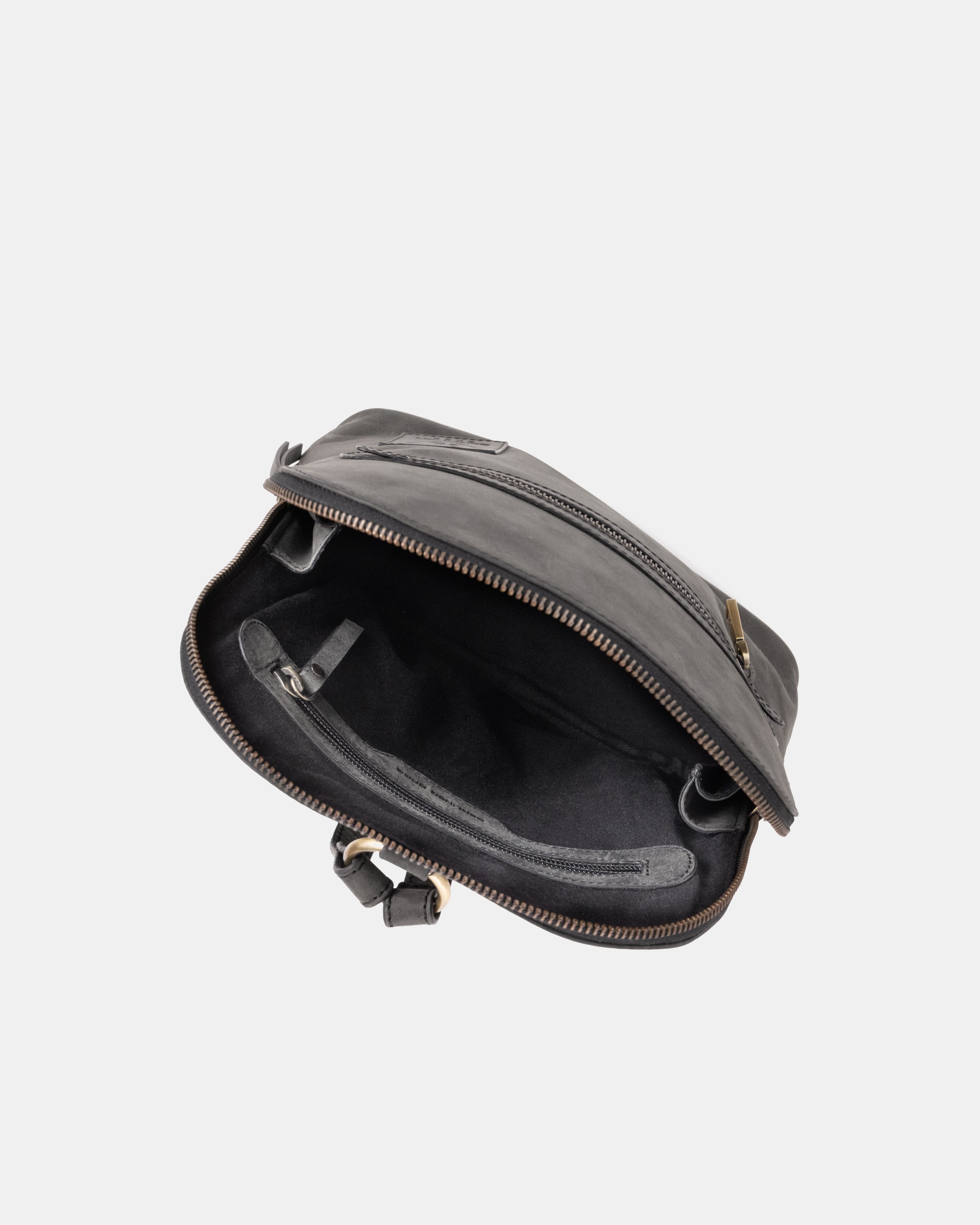 Top-down view of open dark grey leather zip-around backpack