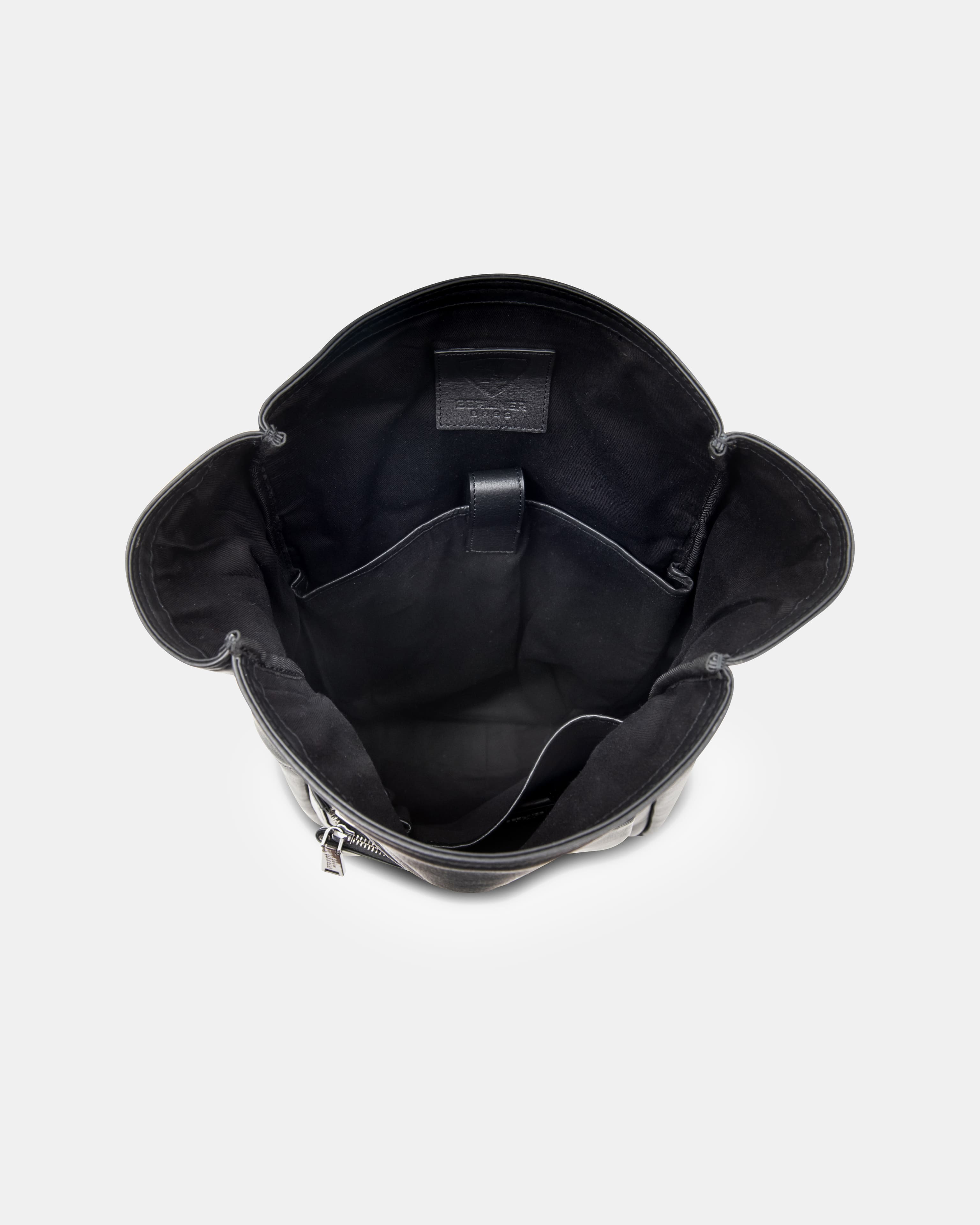 Top-down view showing the open black interior compartment of a black leather backpack