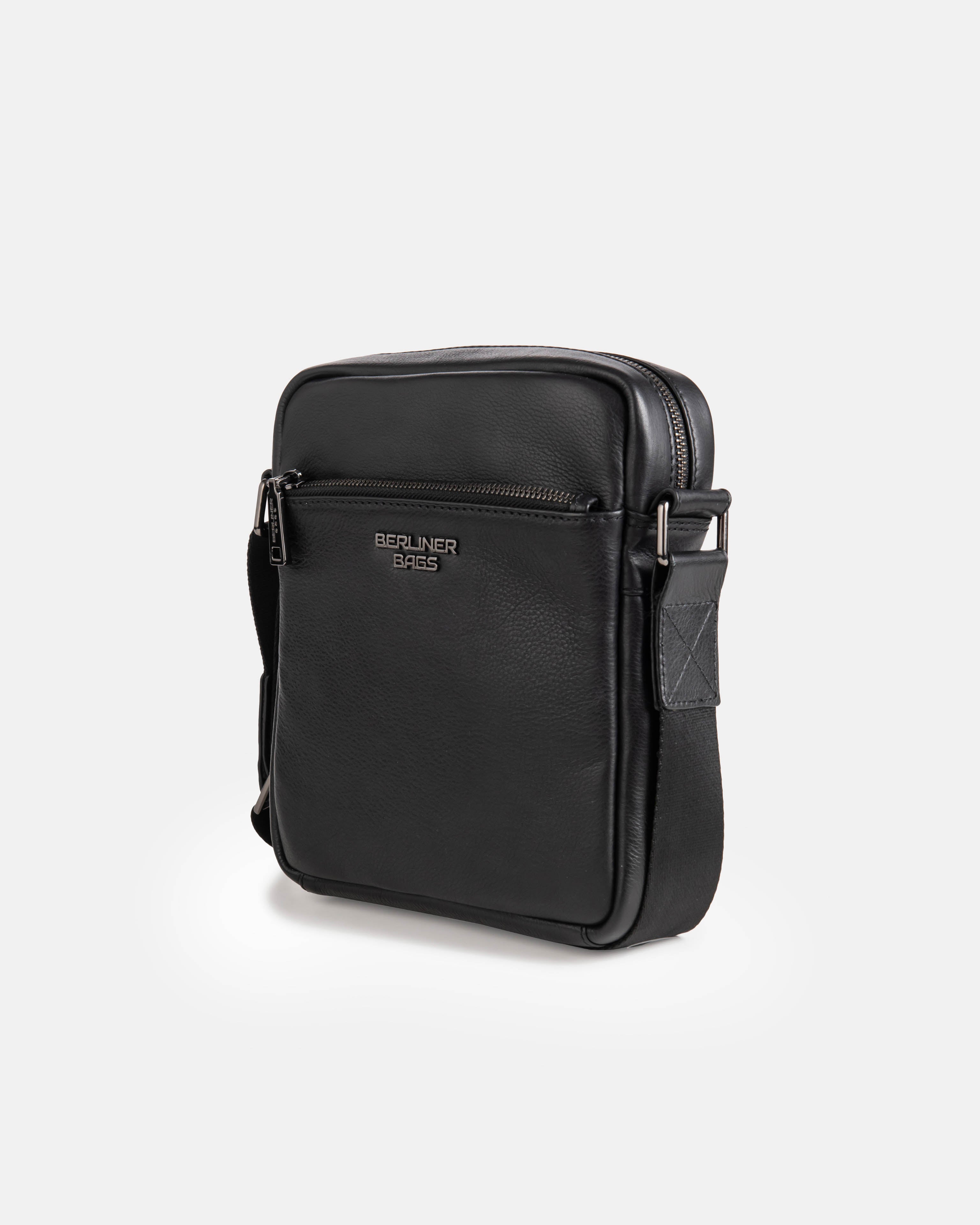 Angled profile of black leather messenger shoulder bag