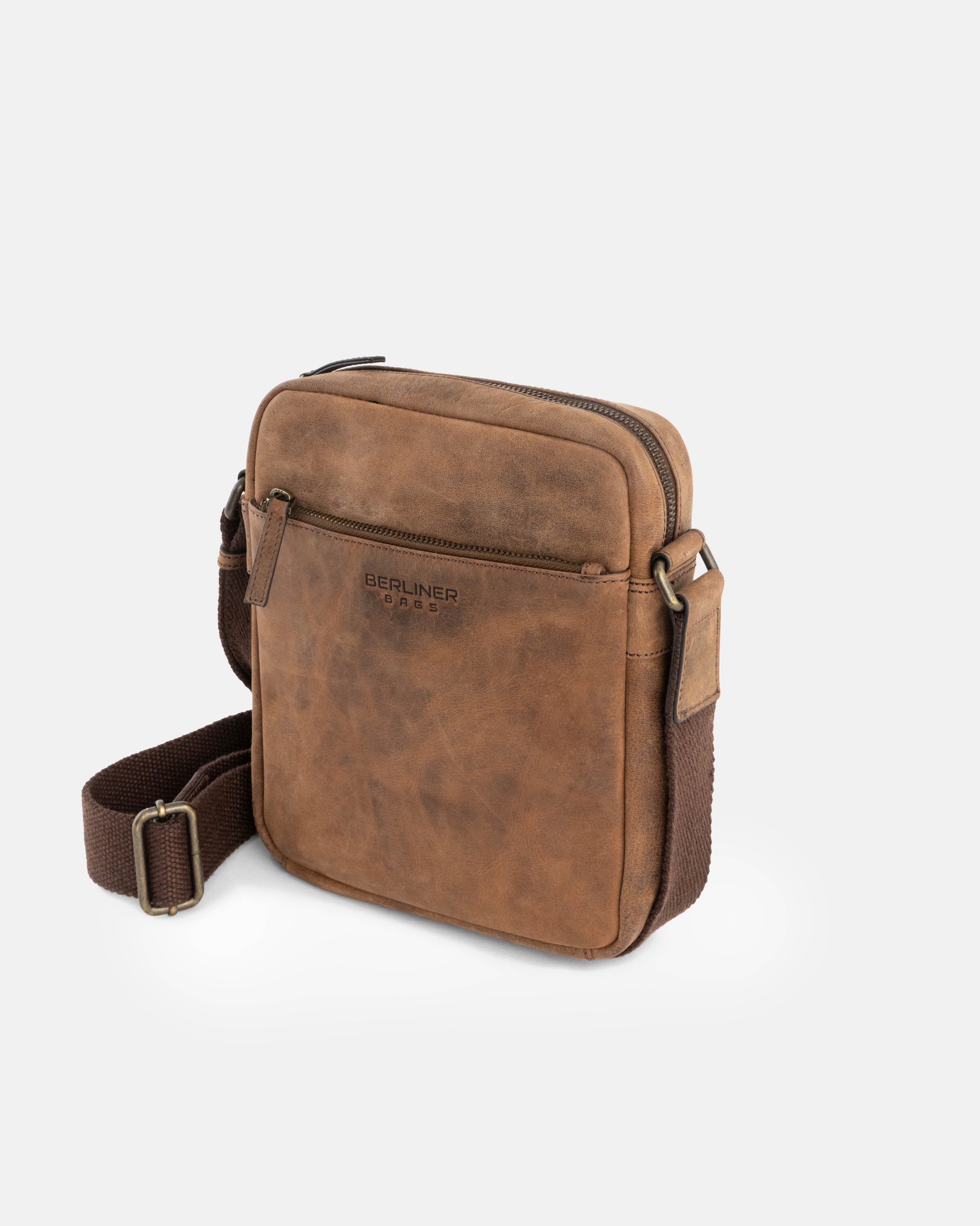 Angled profile of earth leather messenger shoulder bag