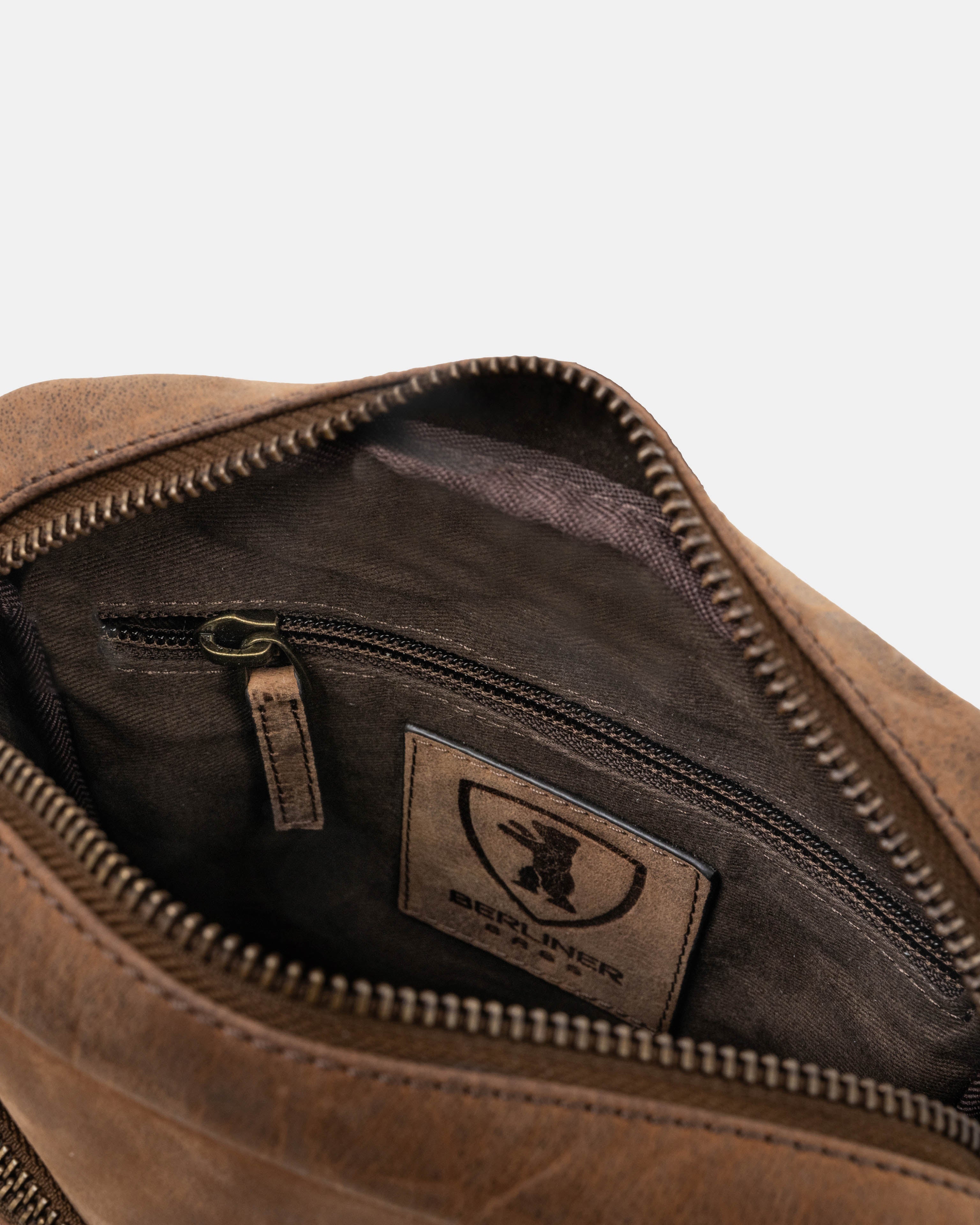 Interior view of earth leather messenger bag zipper pocket
