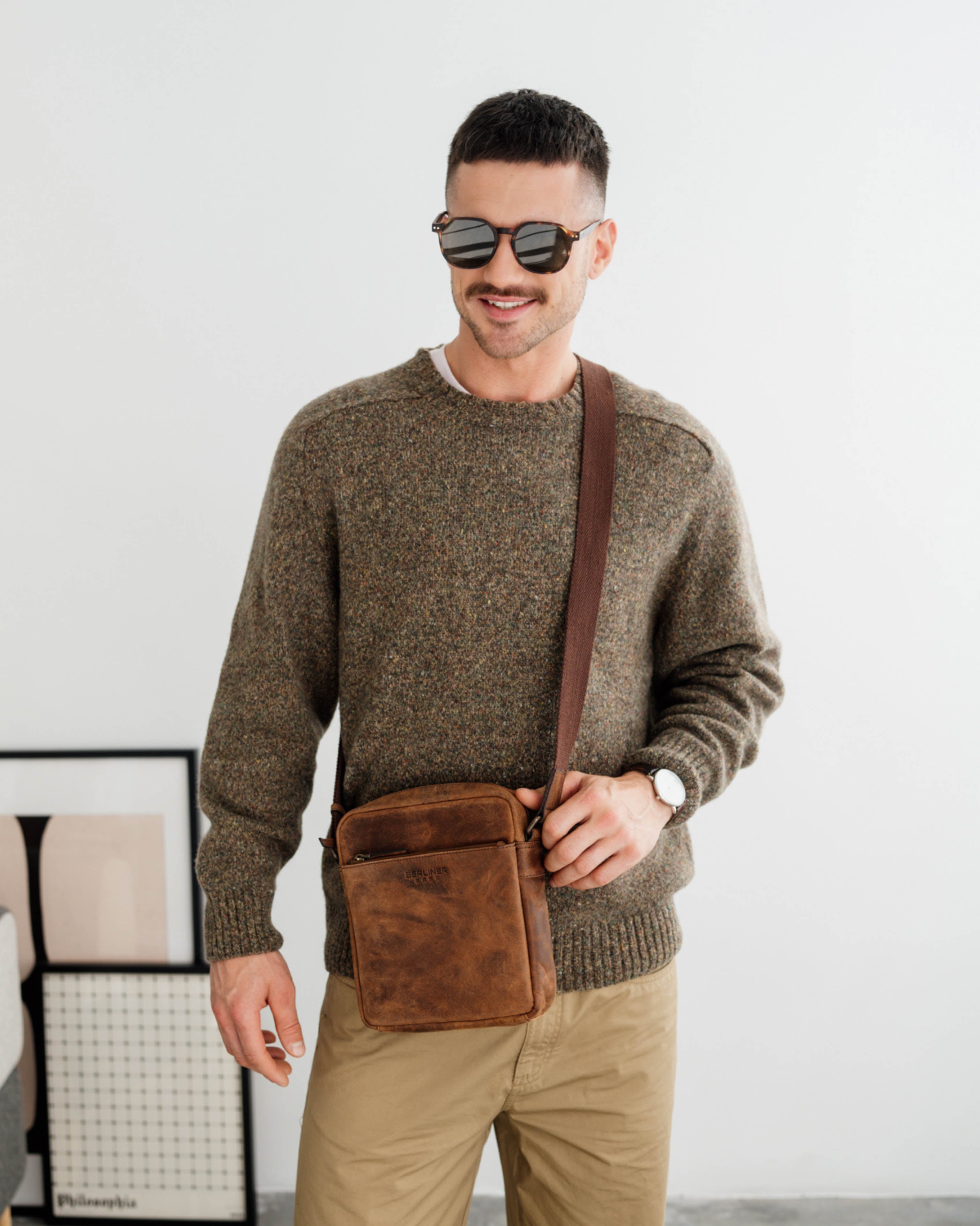 Man wearing earth leather crossbody messenger bag with strap