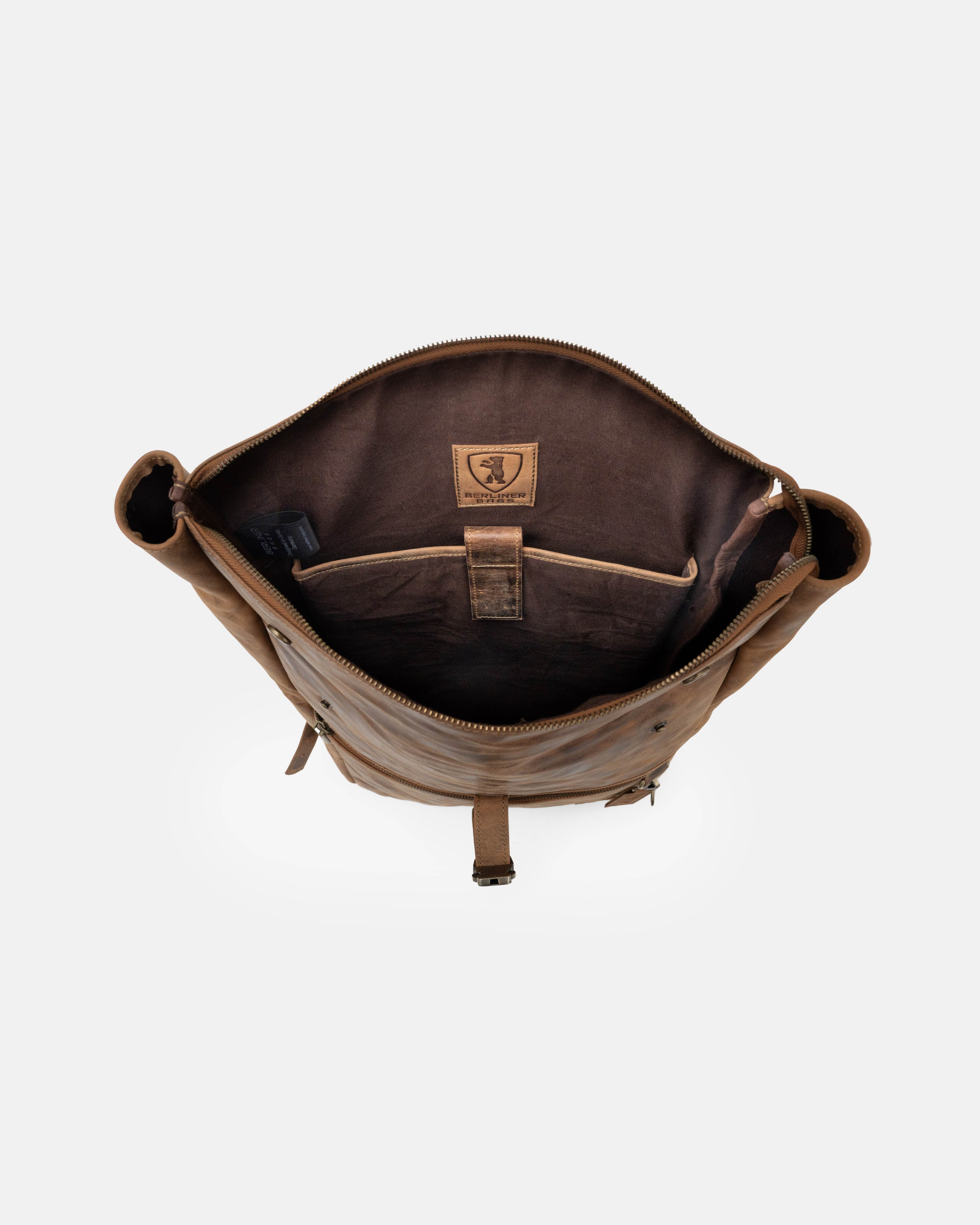 Top-down view showing the open interior of a walnut leather backpack