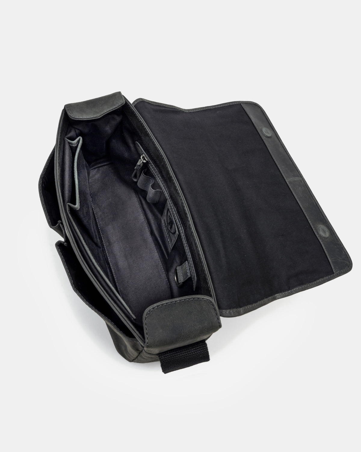 Top-down interior view of an open dark grey leather messenger bag showing the main compartment and organizational slots