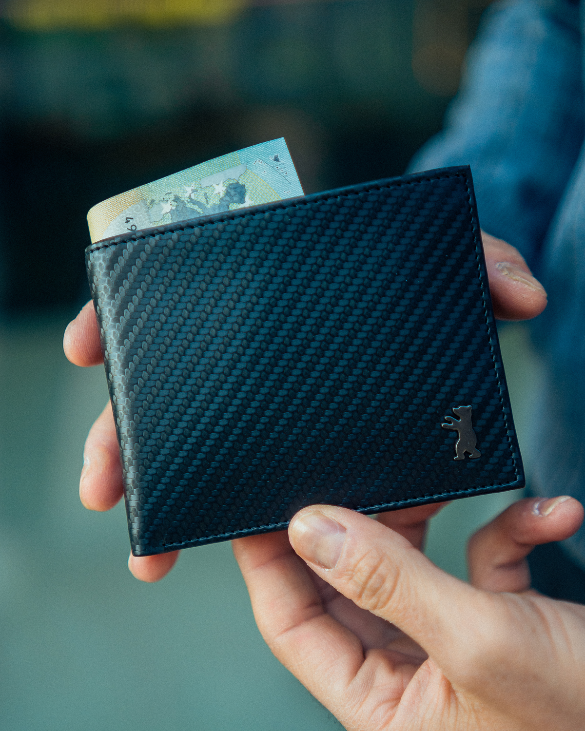 Man showing front view of carbon leather wallet