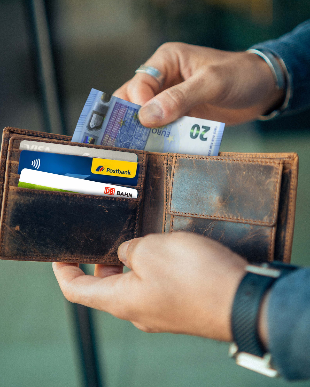 Man holding an open walnut leather wallet with ID flap