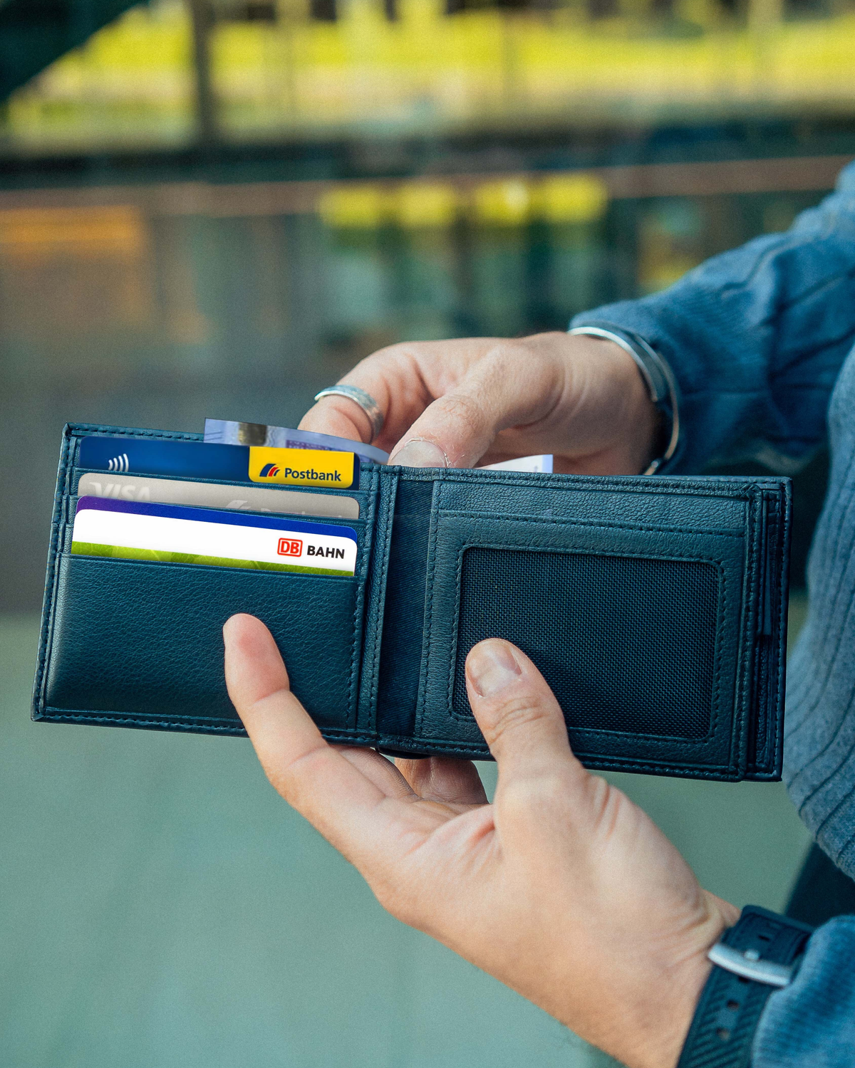 Man open carbon leather wallet showing inside cards slots