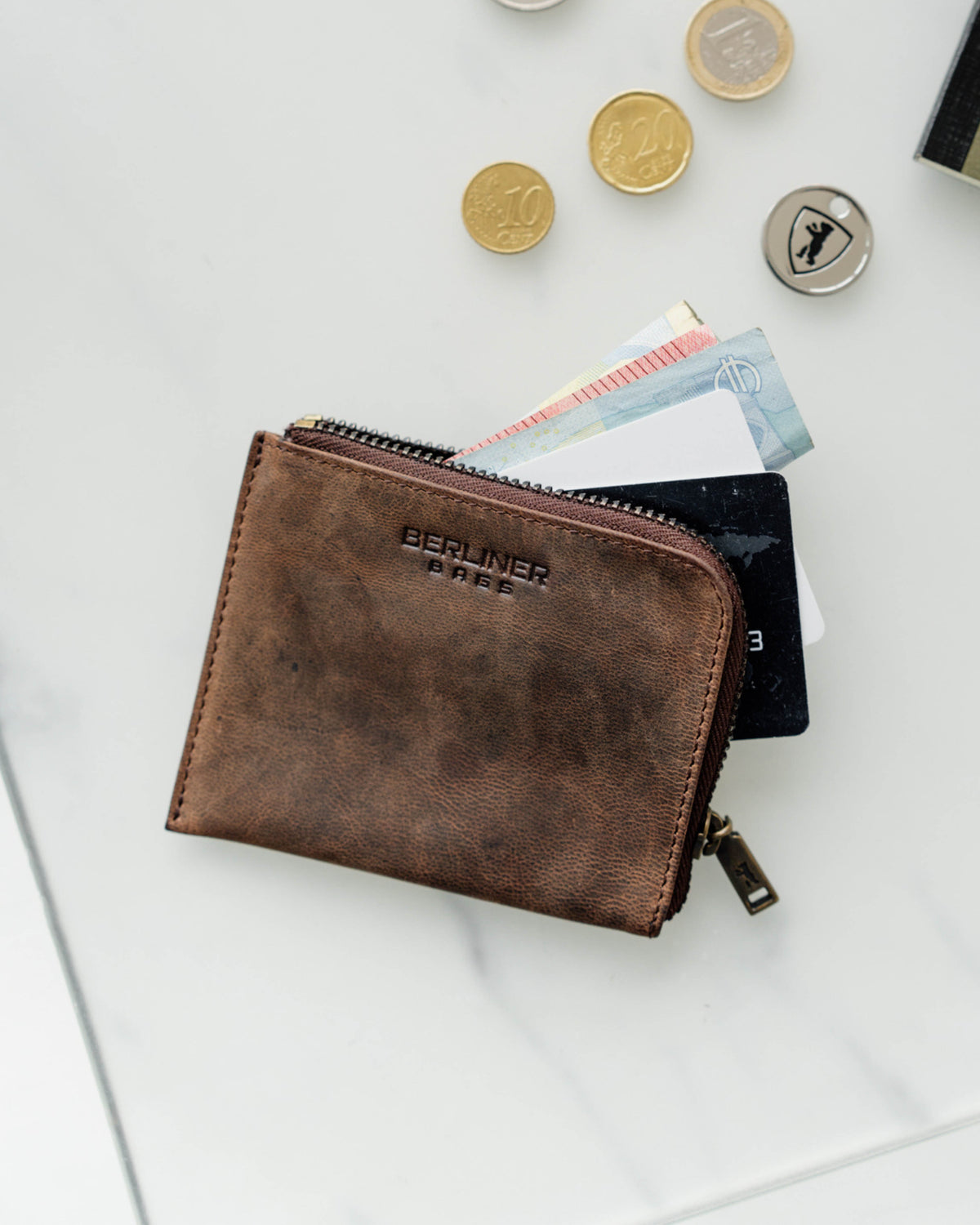 Opening espresso leather wallet showing coin, cash and cards inside