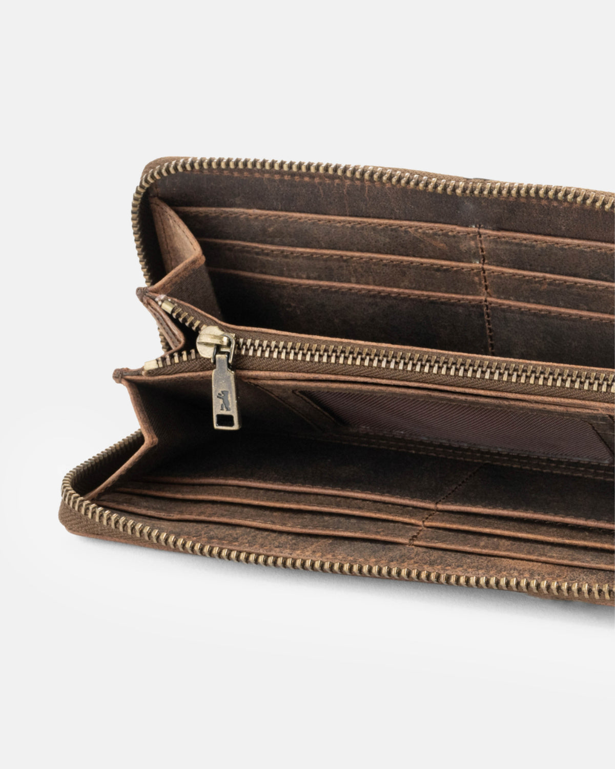 Close-up view of earth leather wallet showing inside slot and metal zipper