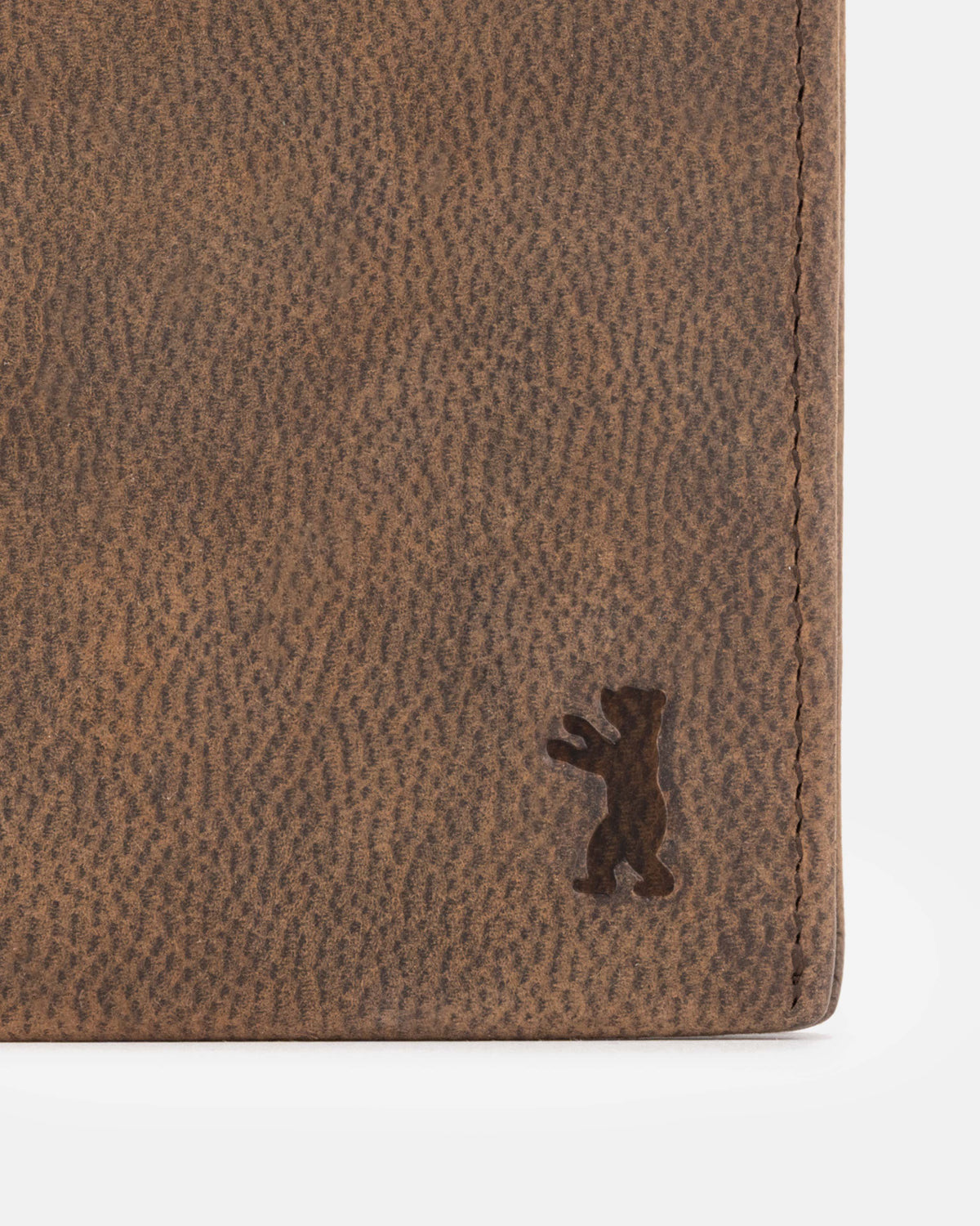 Close-up of a espresso leather wallet with a bear logo