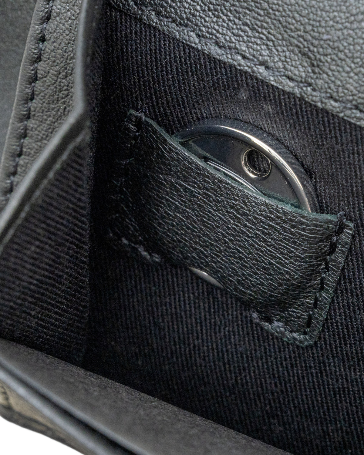 Close-up of interior carbon leather wallet pocket with metal insert