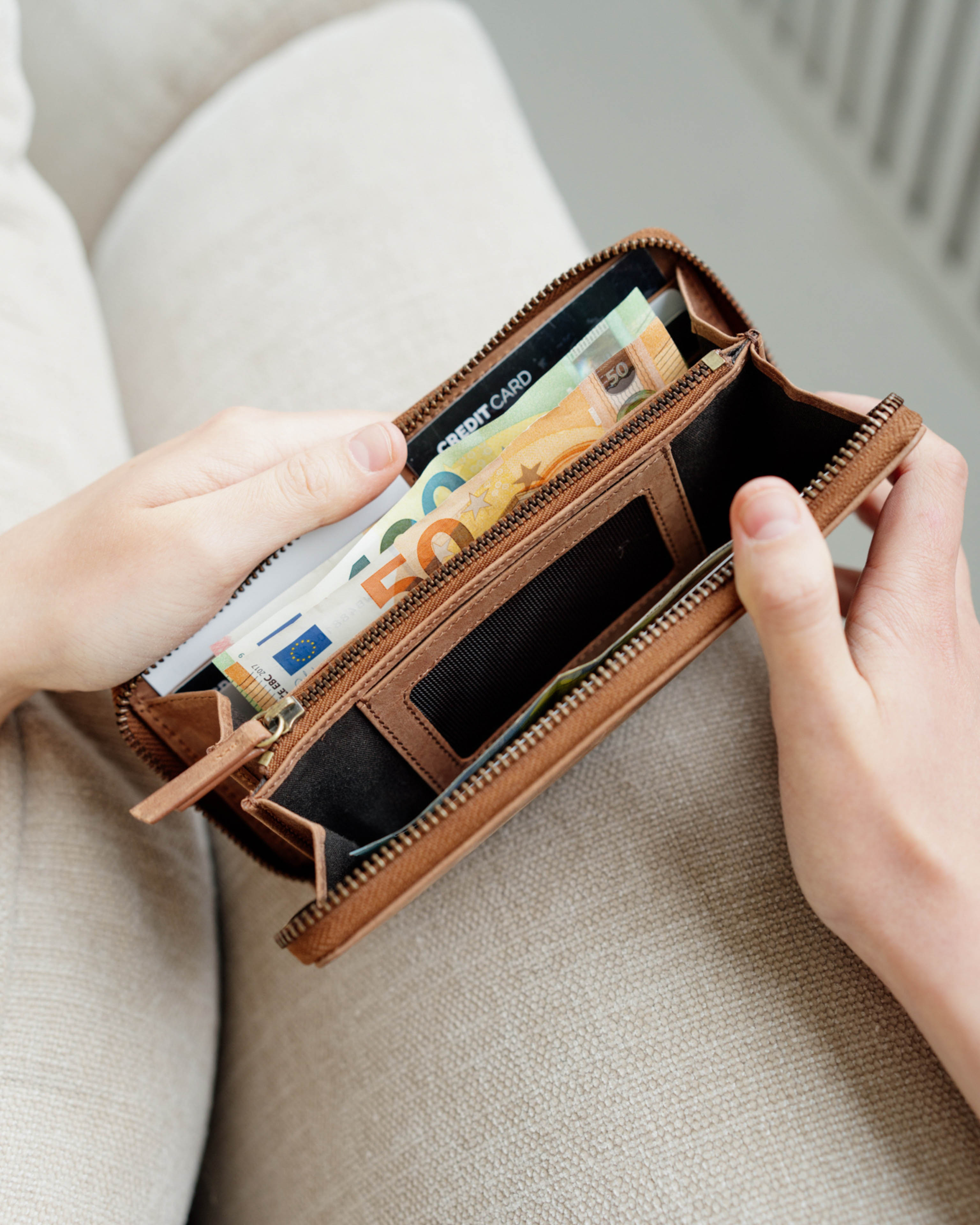 Person showing inside of a camel leather wallet