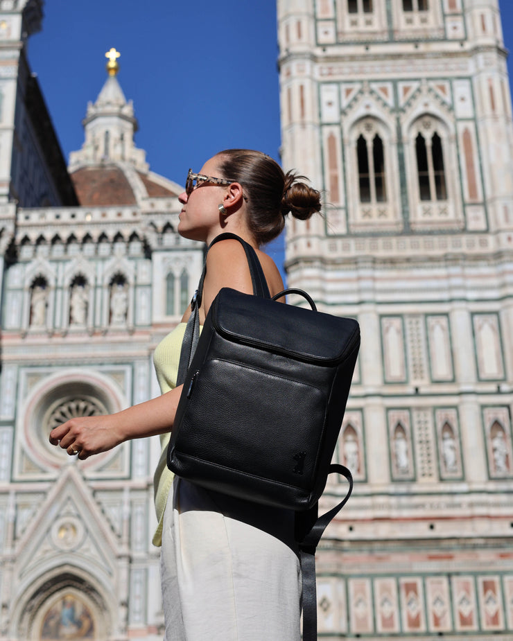Woman wearing black zip-around backpack