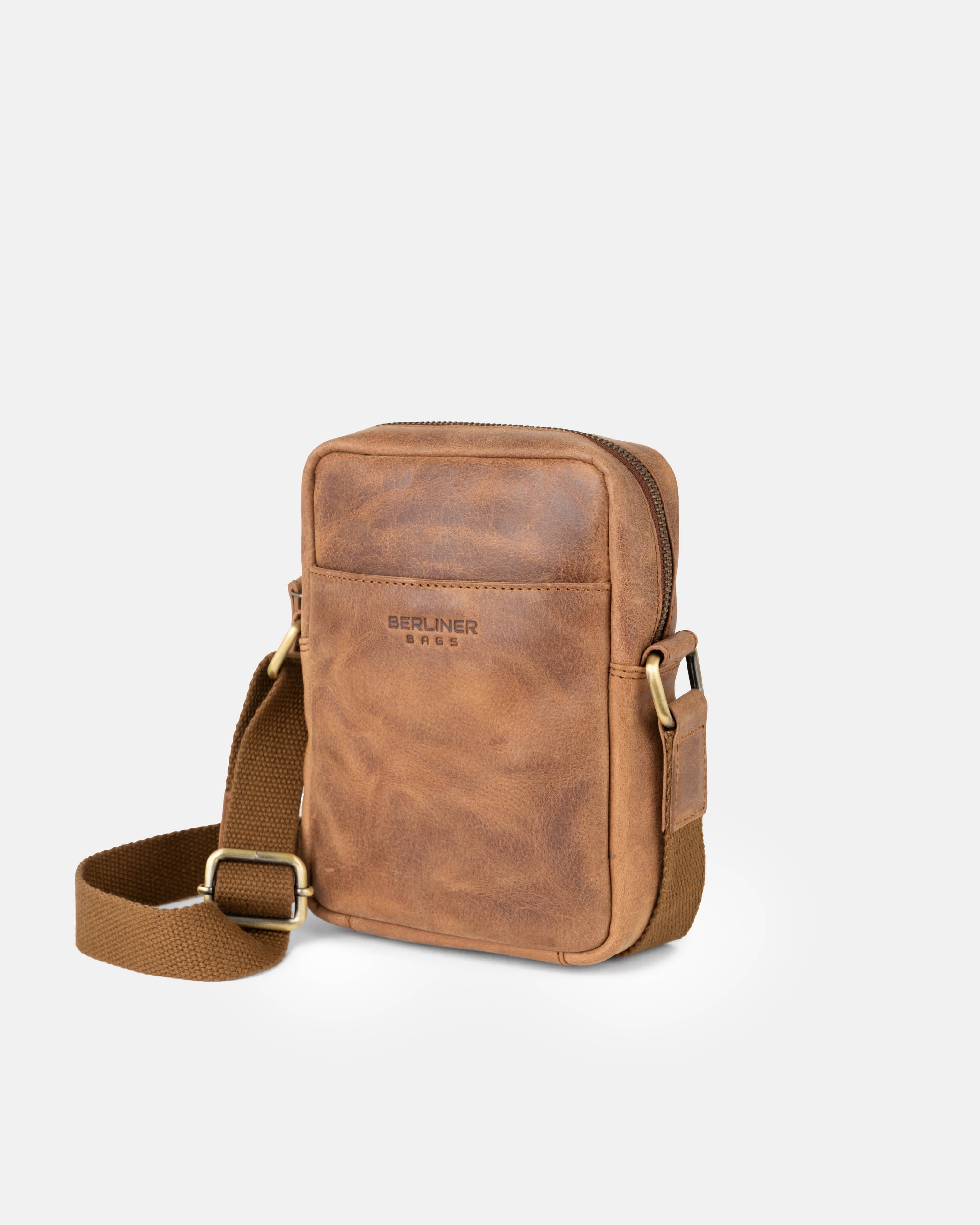 Angled front view of camel leather messenger bag with an adjustable strap