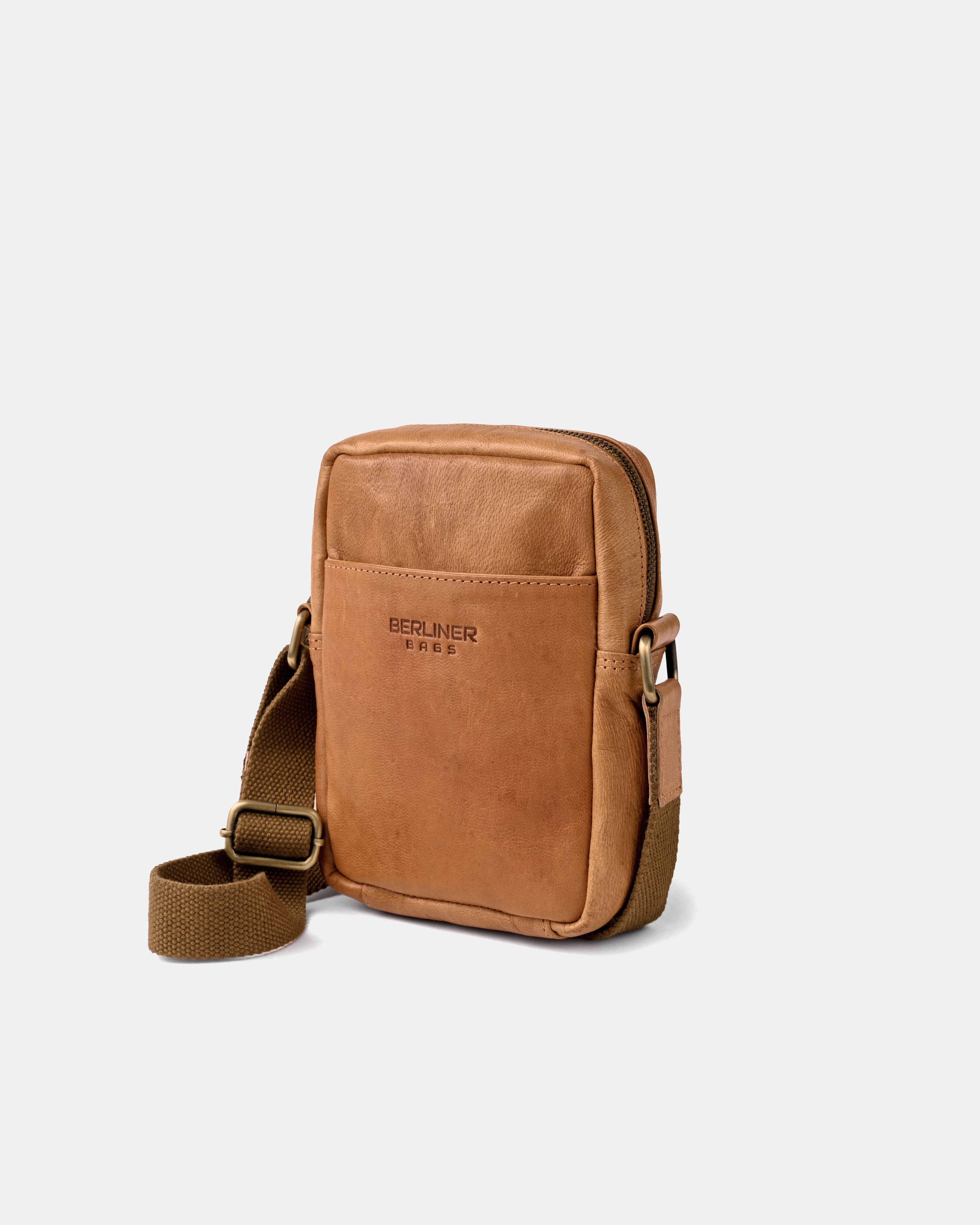 Angled front view of vintage leather messenger bag with an adjustable strap