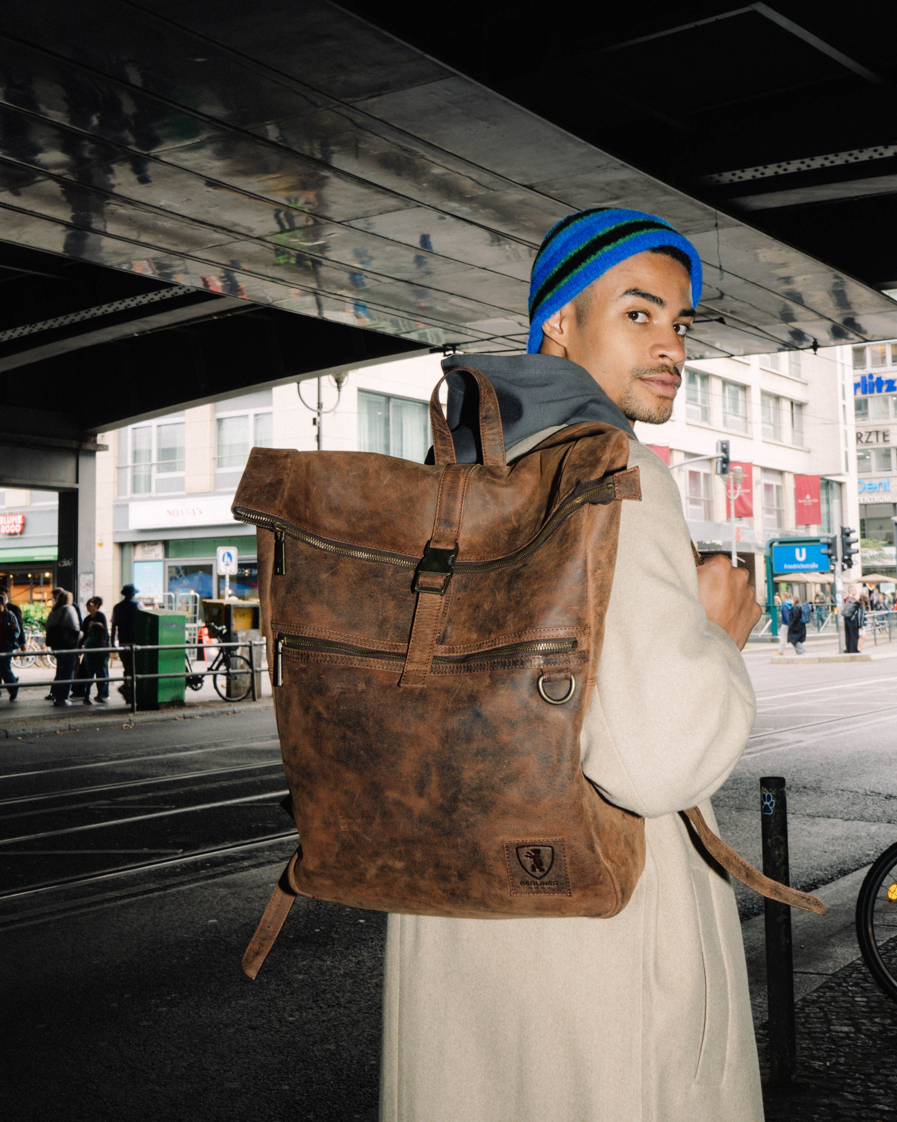 Man wearing earth leather backpack while walking in city