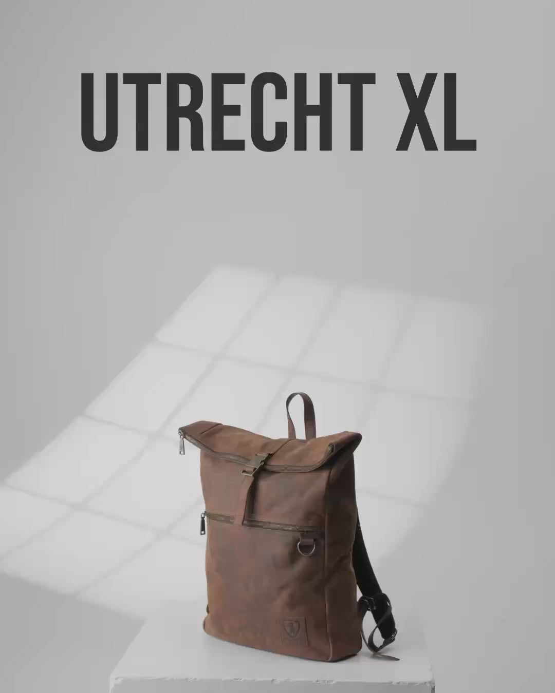 Product shot of Utrecht XL earth leather roll-top backpack.