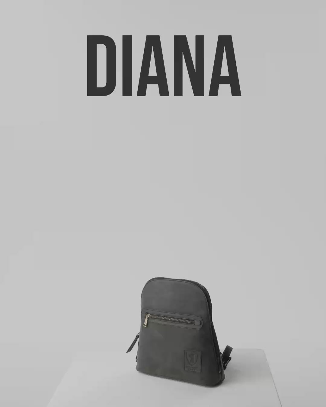 Product shot of a dark grey leather zip-around backpack